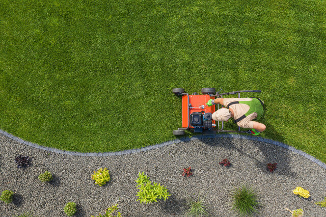 Aerial view of a worker aerating a lawn.